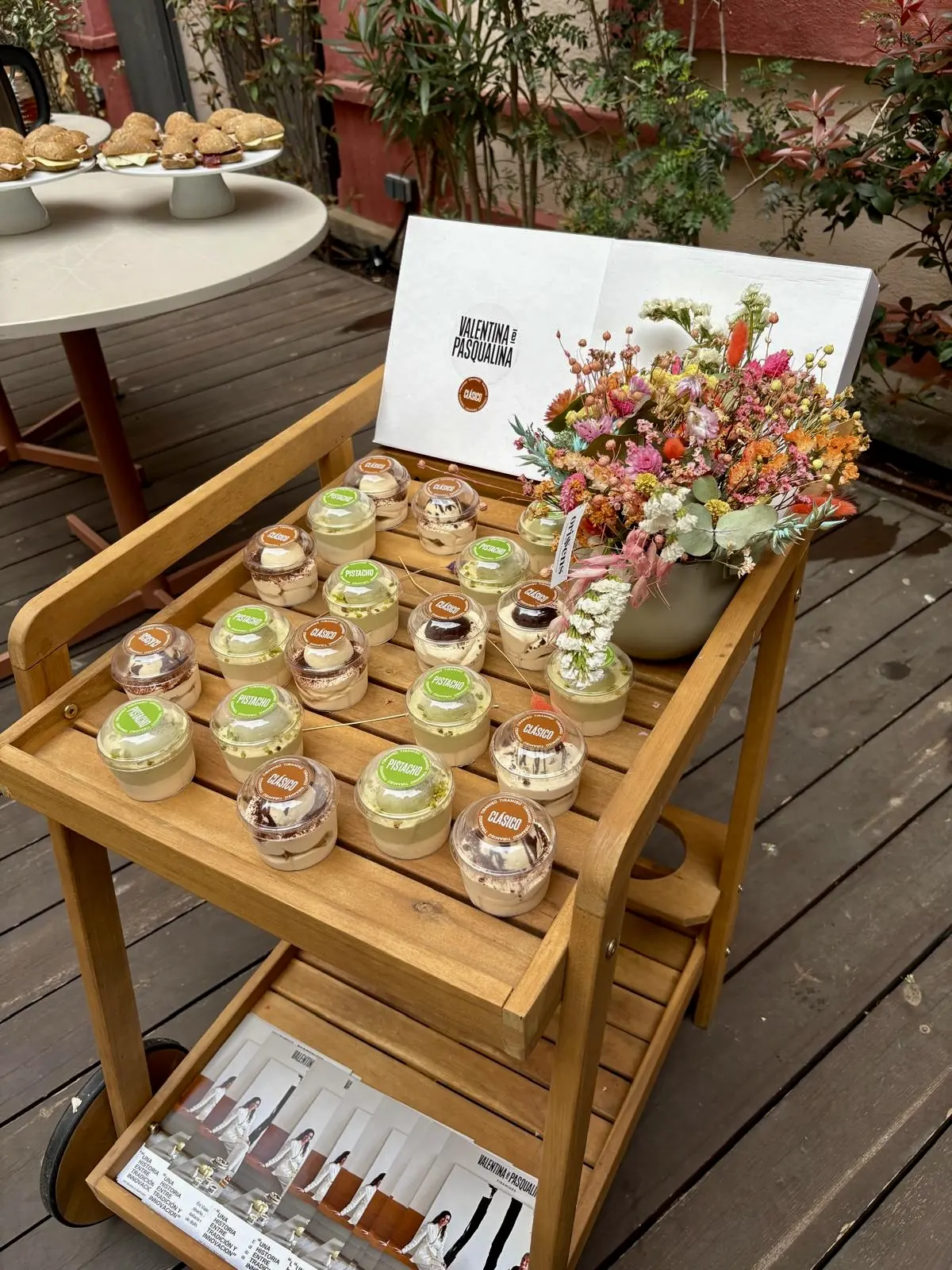 Trolley with desserts, flowers and printed materials from the gathering